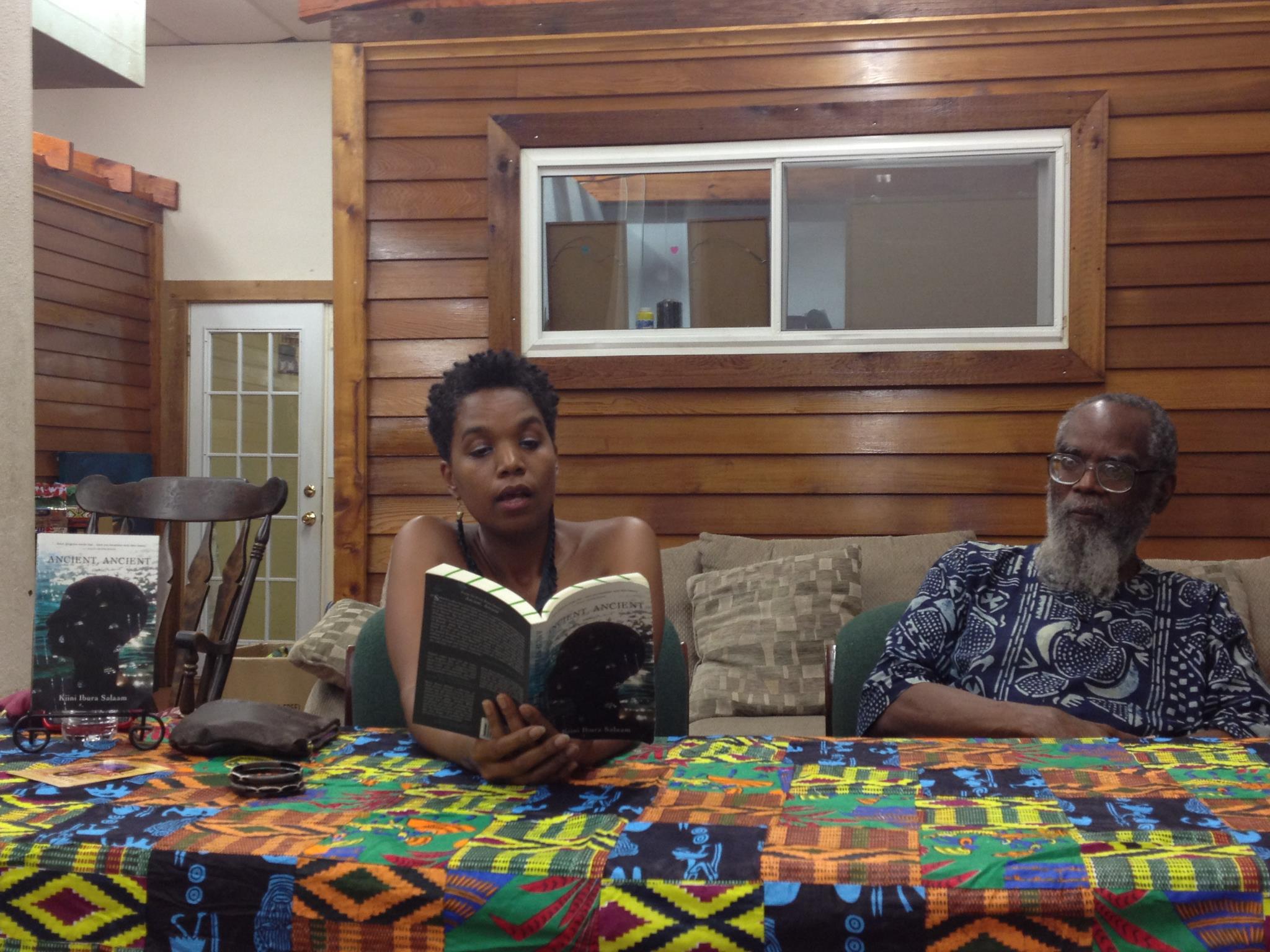 Reading at an event with my father at Community Book Center.